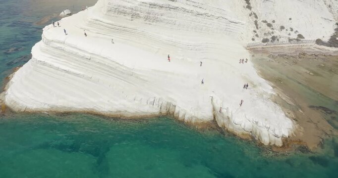 Aerial view of the Scala dei Turchi (Stair of the Turks or Turkish Steps) on the coast of Realmonte, near Agrigento, Sicily, Italy. It's a rocky cliff and tourist attraction. The sea is turquoise.