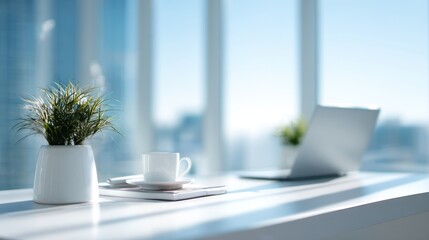Elegant workspace setting, featuring a laptop, plant, and coffee mug on a desk