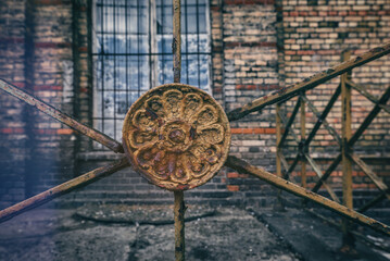 DECORATIVE METALWORK - Very old wrought iron elements of the balustrade in front of the industrial building
