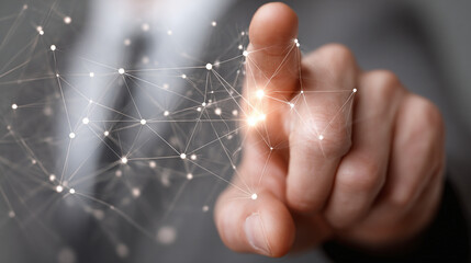 Digitally connected: A finger interacts with a network of nodes and lines, representing modern technology and digital connectivity. Data flow.