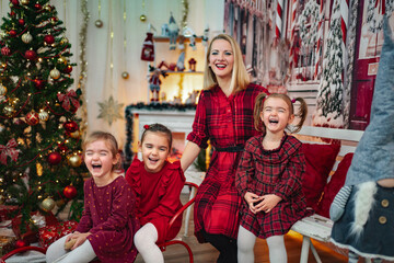 Mother and three daughters laughing enjoying Christmas holiday together