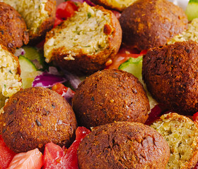 Delicious falafel served on a fresh vegetable platter for a healthy meal