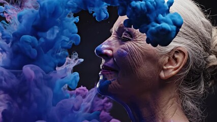 Senior woman with closed eyes exhaling vibrant purple and blue abstract smoke, expressing deep creativity, inspiration, and artistic freedom with painted face details against a dark background - Powered by Adobe