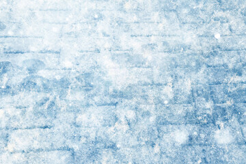 Footprints in the snow, winter background, pavement surface with footprints in the city, winter weather background