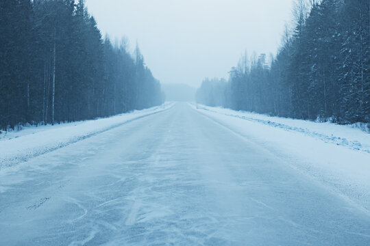 Fototapeta empty winter road, snow background in the surrounding landscape