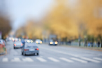 Autumn blurred background of trees in a city park, seasonal backdrop for design