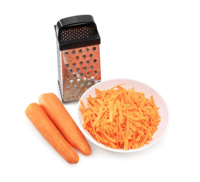 Two peeled carrots, a metal box grater,and a white bowl of shredded carrots,forming an isolated composition on a white background.
