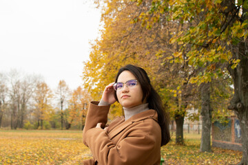 Portrait of a young attractive woman wearing a brown coat 