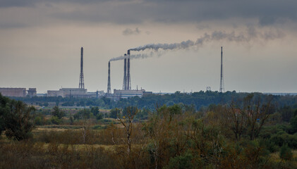Large industrial area with smoke coming out of the smokestacks