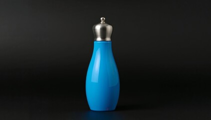 Blue Vessel with Metallic Top. A Study in Form, Color, and Texture Against Dark Backdrop.
