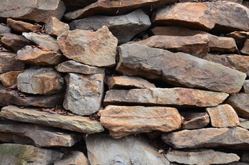 The texture of rubble masonry, which strengthens the crumbling hill.