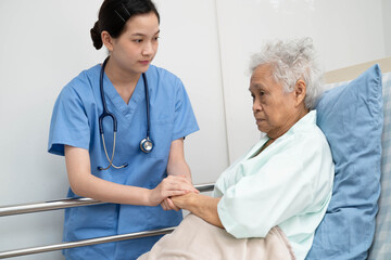Asian doctor checking and treat elderly woman patient health in hospital.