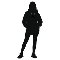 Black vector silhouette of young fashionable woman standing in sporty winter urban street fashion outfit: oversized hoodie dress, leggings, and athletic shoes. Isolated design element.