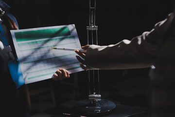 Close up high angle Asian businesswoman working with her coworker in meeting room