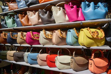 Close-up of women's leather handbags made in Italy, for sale at a street market