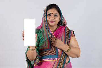 Indian young woman holding Aadhar card isolated 
on grey studio background