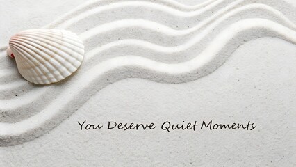 Flat lay of beach sand with seashell and inspirational quote