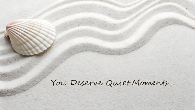 Flat lay of beach sand with seashell and inspirational quote