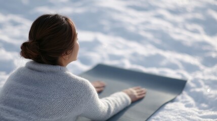 Young female in a yoga pose and warm clothes, focusing on inner peace.