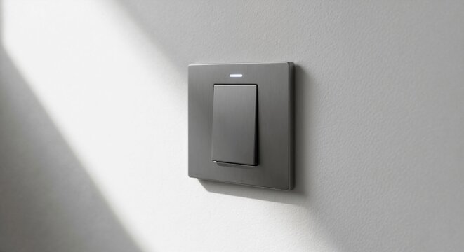 A modern, dark gray light switch with a brushed metal finish on a textured wall. Minimalist smart home technology with an illuminated LED indicator. Close-up of an electrical fixture with copy space
