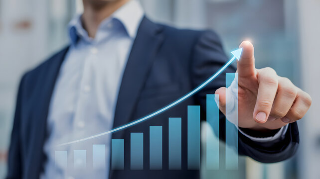 Businessman pointing at a rising graph showing financial growth and success in business