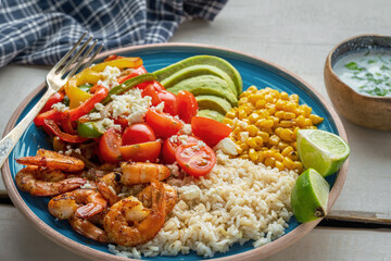 Grilled Shrimp Rice Bowl with Avocado and Corn. Close up shot.