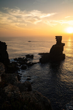 Sunset Light Reflecting on Atlantic Waters Beside Nau dos Corvos Rock Formation at Cabo Carvoeiro in Peniche, Portugal