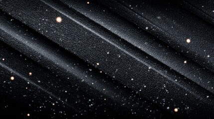 Elegant dark textured surface with a scattering of gold and silver sparkles adding a touch of