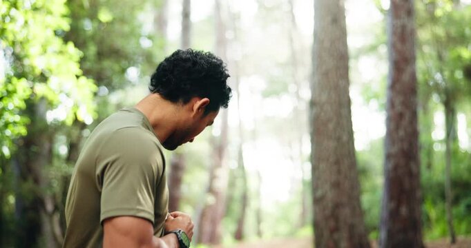 Athlete, man and check smart watch in nature for fitness app, tracking progress and start timer. Male person, wristwatch and running for exercise, monitor heart rate and step count of cardio training