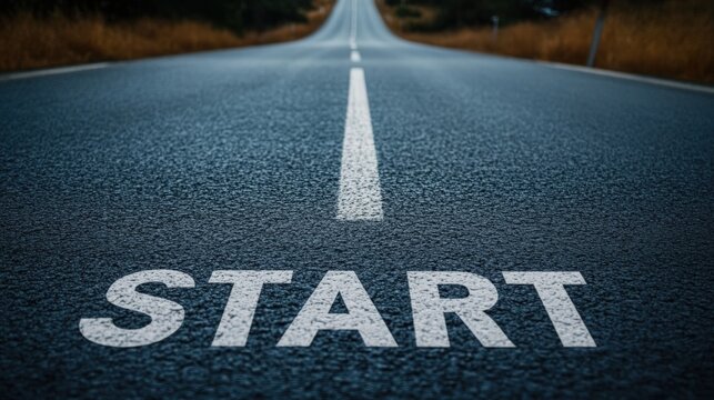 An inviting view of a road with the word "START" painted prominently, symbolizing new beginnings and journeys ahead.