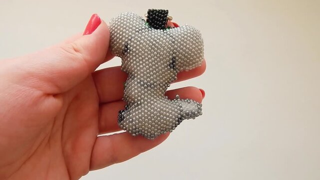 Cute keychain in the shape of a mouse in a woman s hand