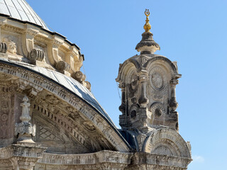 Istanbul, Turkey - August 29, 2025: Upper tower structure and ornate stone decorations of Ortakoy Mosque