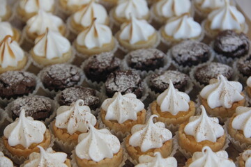 Assorted mini desserts with brownies, suspiros, and passion fruit pie—sweet, colorful treats perfect for any occasion.