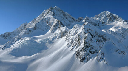 Snow-covered mountain peaks against a bright blue sky.