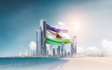 Lesotho flag waving behind modern skyline. Lesotho national flag for independence day.