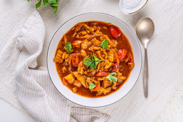 Spicy tripe soup made of beef with cabbage, red peppers and tomatoes