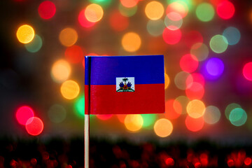 Haitian flag against a beautiful, glowing rainbow bokeh background. Ideal for Independence Day,...
