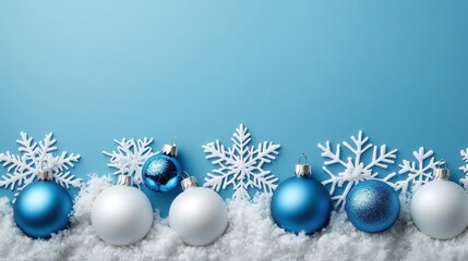 A festive arrangement of blue and white Christmas ornaments and snowflakes against a light blue background, evoking a cheerful winter atmosphere.
