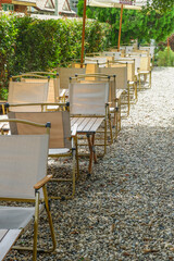 Colorful folding camping chair,wooden and chair set in garden on a sunny day,outdoor seating for restaurant or cafe.