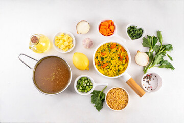 Tasty Italian Penicillin Soup, autumn winter immunity booster chicken vegetables orzo soup. Traditional european comfort food with ingredients for cooking on white table