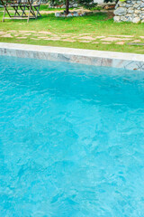 Empty swimming pool with sunbed and white umbrella in resort hotel for vacation leisure and white sand,resort neary sea and beach in summer.