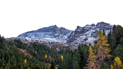 Lightly snow-capped mountains against a backdrop of green and yellow fir trees. Isolated on a transparent background. Autumn/winter mountain landscape. PNG