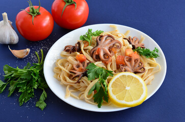 Delicious Seafood Pasta with Baby Octopus and Fresh Tomatoes close up