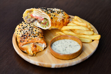 Fresh tasty beef shawarma with white sauce and french fries on plate