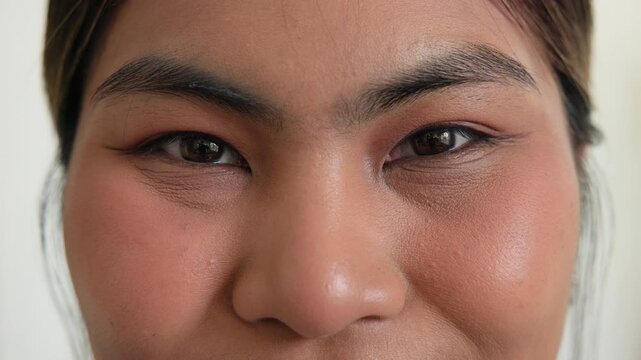 Close up front view south asia people gen z teen face eye nose look at camera laugh relax smile happy self love real glow skin brown shade body care. Dark black eyes anti aging young adult asian woman