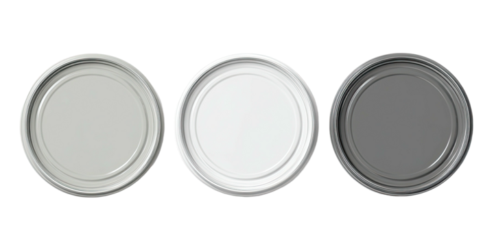 Overhead shot showcasing three metallic circular container lids with varied shades on a black background