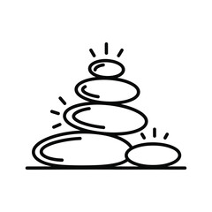 Stack of balanced smooth stones with radiating light, representing spa or zen