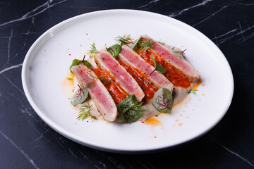 Seared Tuna Steak Slices on Creamy Sauce with Fresh Greens