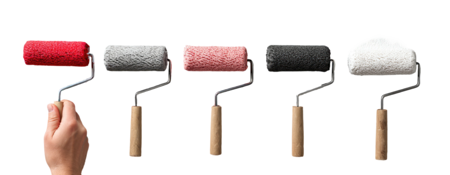 A hand holds a red paint roller, four others with varying colors lay next to it, against a black backdrop