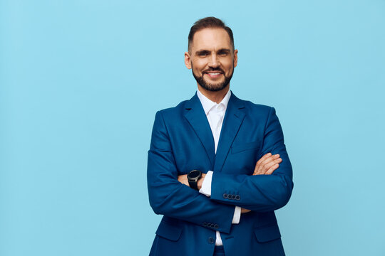 A confident business professional stands against a solid colored backdrop, showcasing a polished look and poised demeanor. His blue suit and composed posture convey reliability, leadership, and
